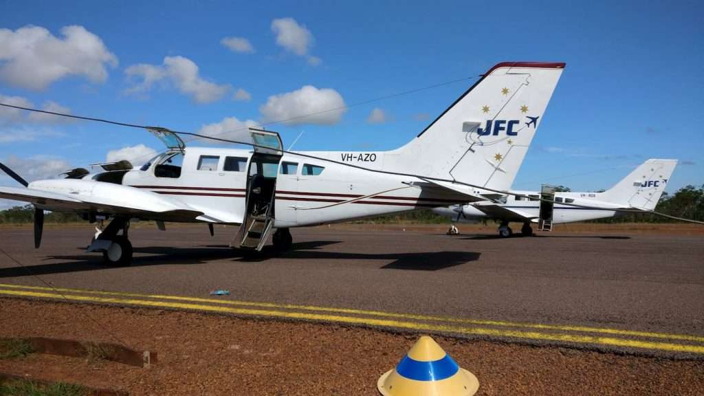 JFC Cessna 402 charter aircraft at a regional airstrip